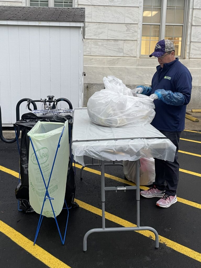 Man sorting trash at a table