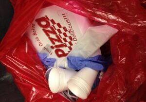 Pizza box in the red bag waste